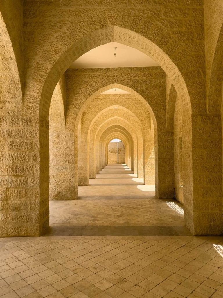 A golden arched hallway in warm light