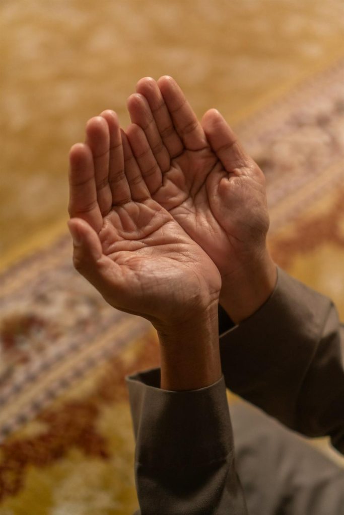 Hands raised in prayer with palms open