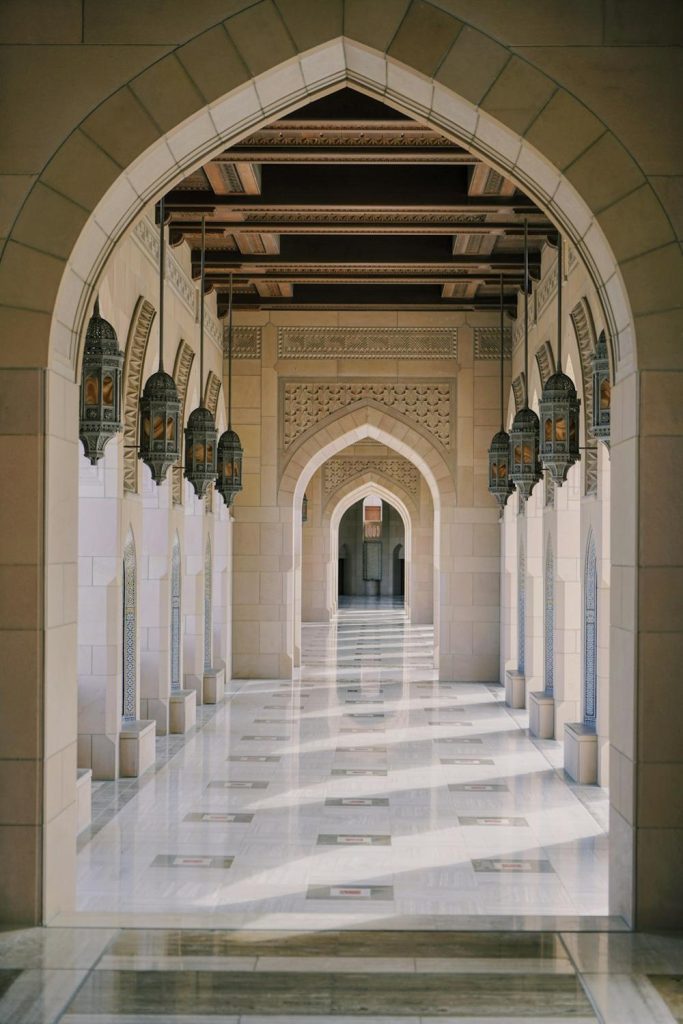 A calm hallway with columns and Islamic arches